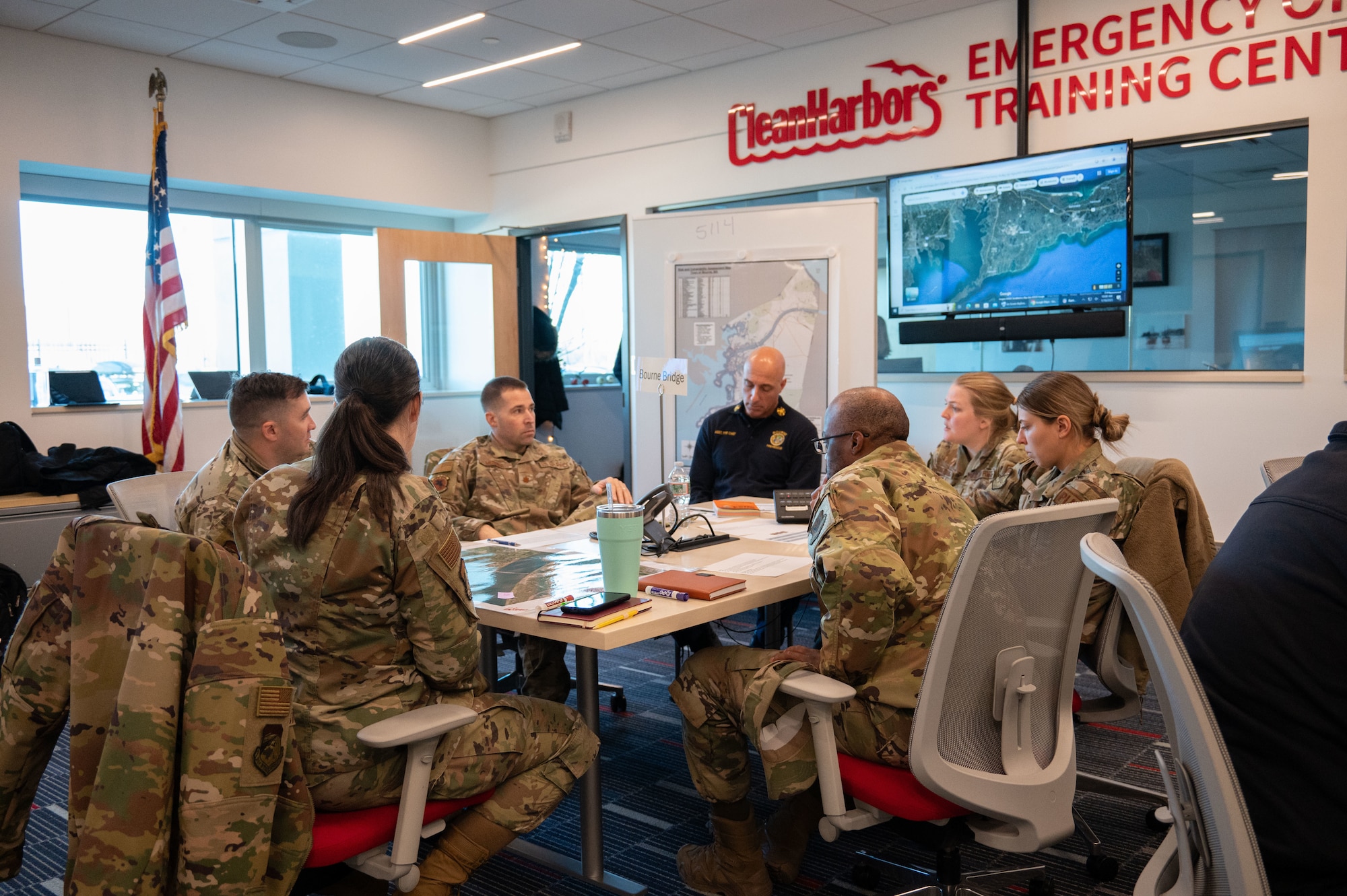 Airmen sit around a table.