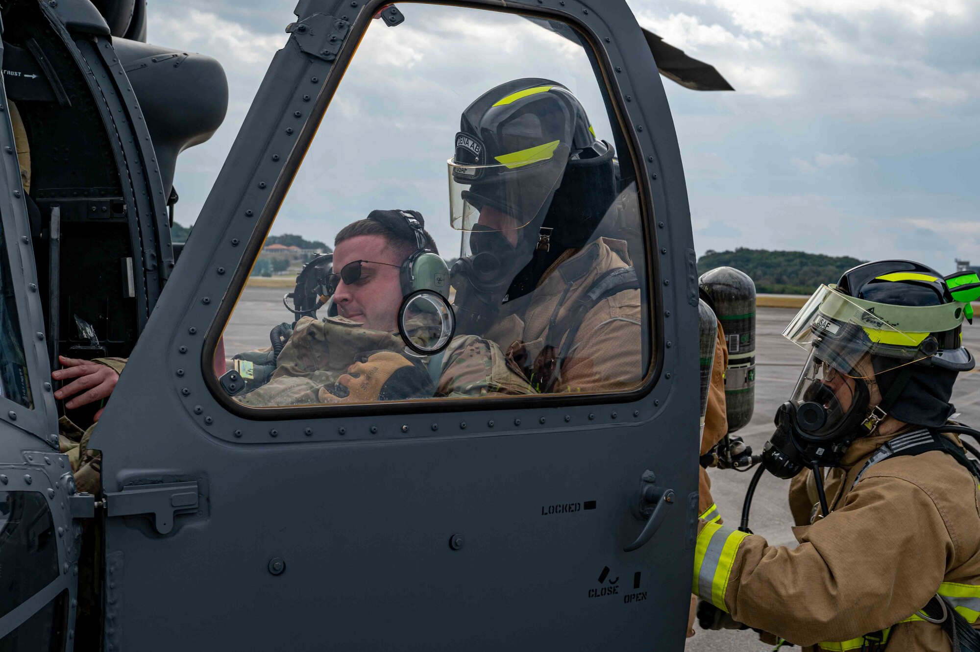 Simulated casualty service member is being moved into a helicopter