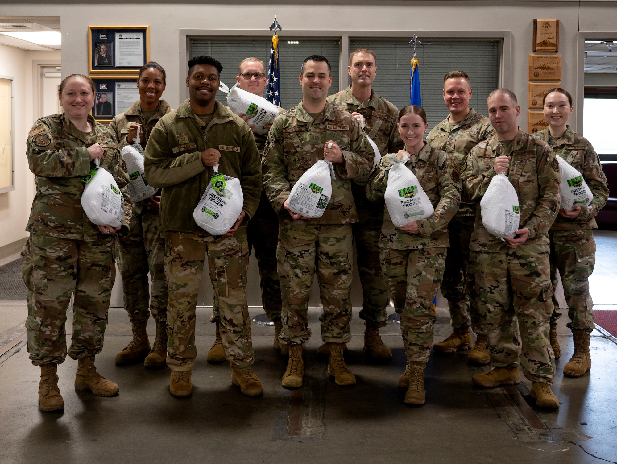 First sergeants from the 446th Airlift Wing hold up turkeys for a photo at Joint Base Lewis-McChord, Washington.
