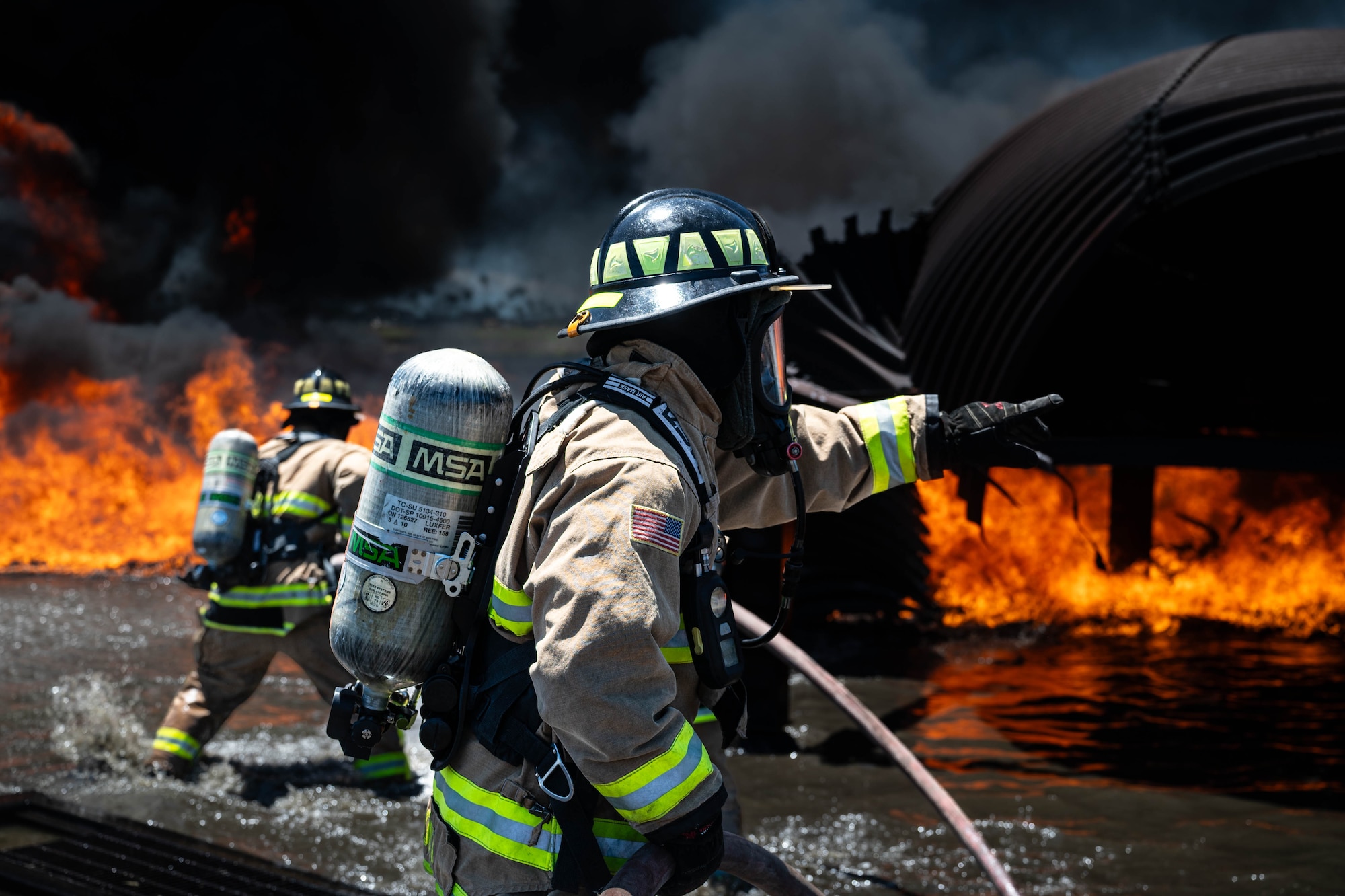 A Reserve Citizen Airman from the 624th Civil Engineering Squadron gives critical instructions while directing teammates during a live firefighting exercise in Kahului, Maui, Sept. 8, 2024.