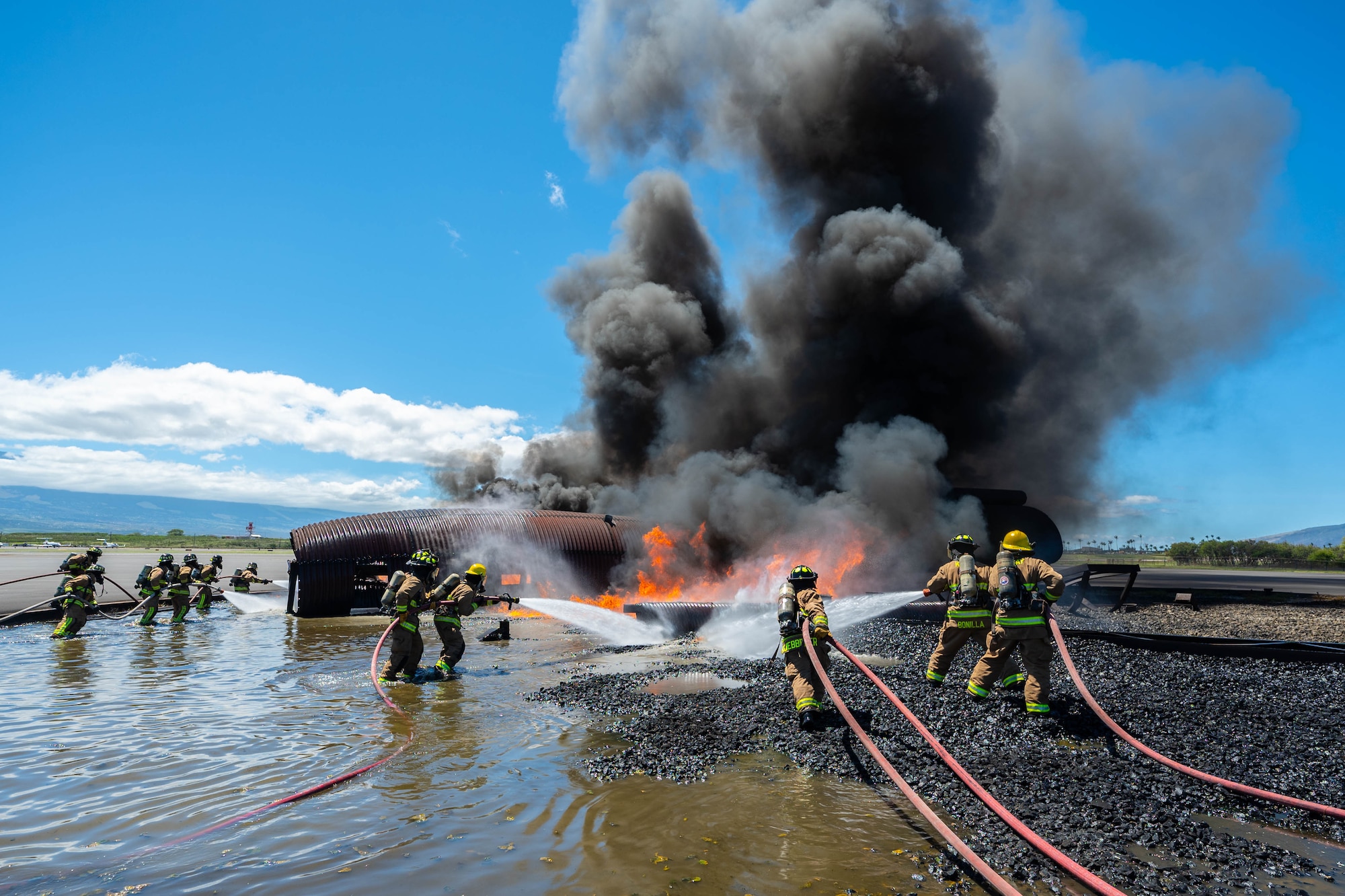A Reserve Citizen Airman from the 624th Civil Engineering Squadron gives critical instructions while directing teammates during a live firefighting exercise in Kahului, Maui, Sept. 8, 2024.