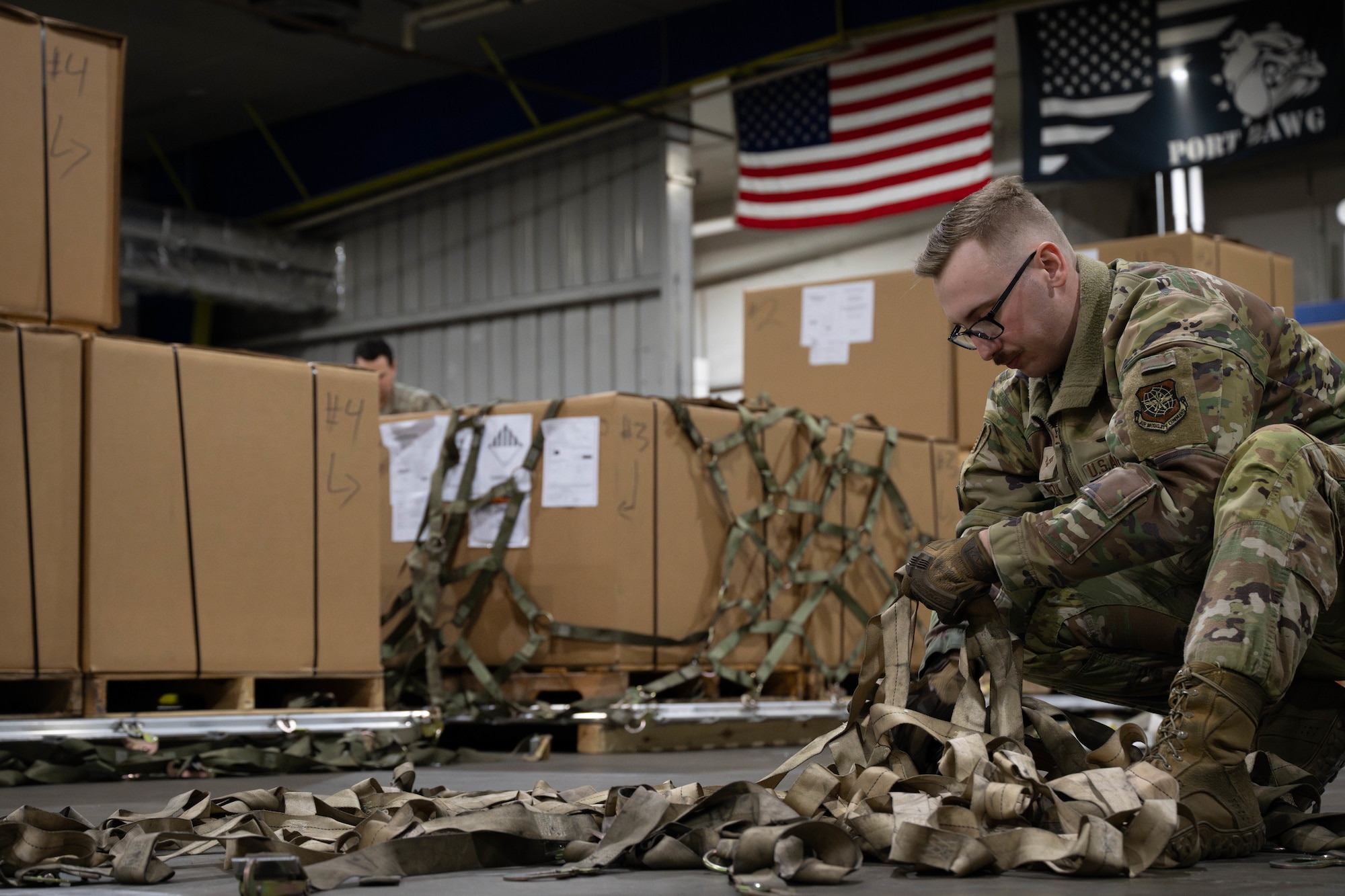 U.S. Air Force Senior Airman Joshua Masczak, 305th Aerial Port Squadron special handling specialist, prepares to palletize  food rations at Joint Base McGuire-Dix-Lakehurst, N.J., Jan. 8, 2025. The 305th APS supports an ongoing mission to U.S. European Command area of operations where essential goods are supplied to sustain their mission. (U.S. Air Force photo by Senior Airman Aidan Thompson)