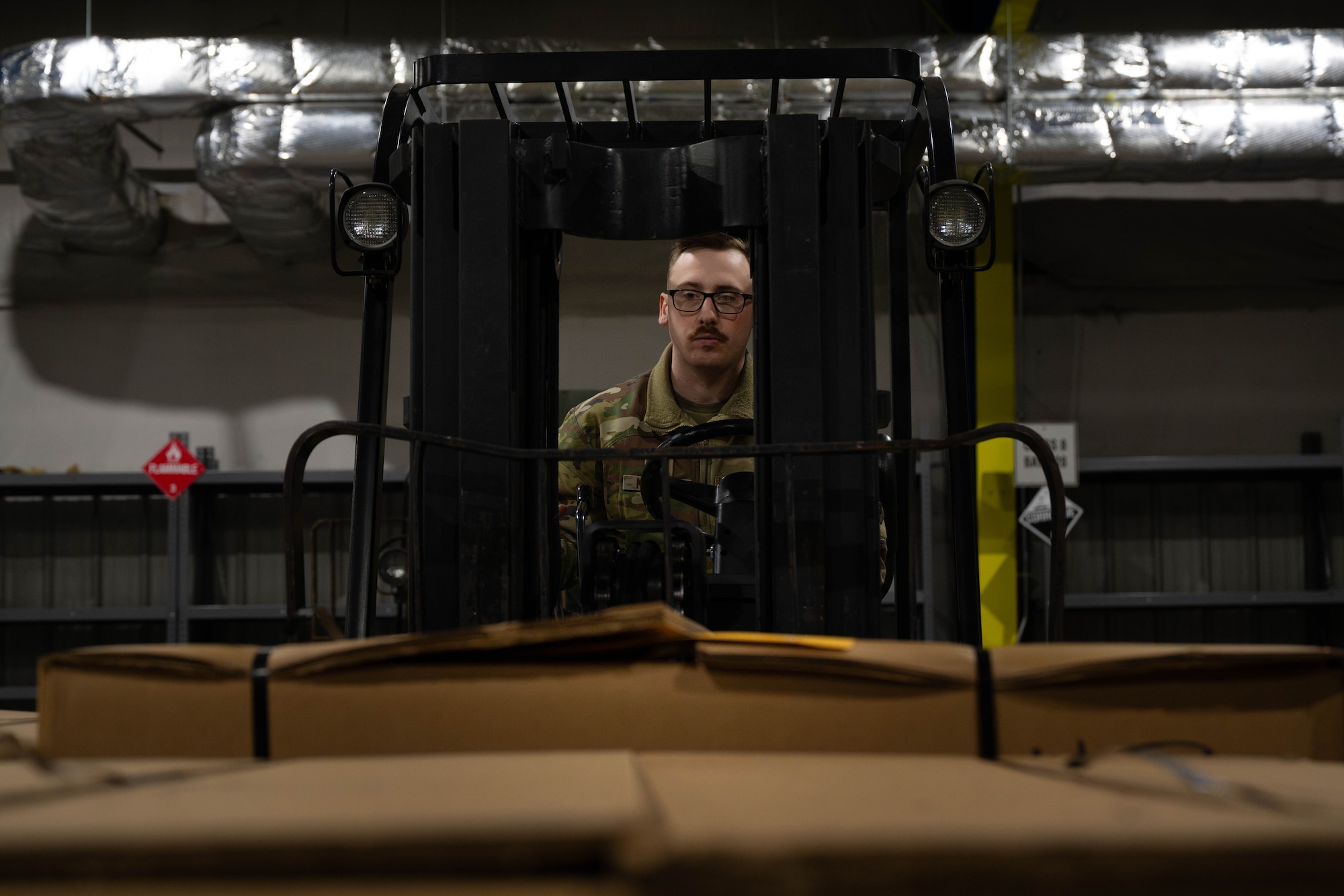 U.S. Air Force Senior Airman Joshua Masczak, 305th Aerial Port Squadron special handling specialist, loads food rations onto a pallet at Joint Base McGuire-Dix-Lakehurst, N.J., Jan. 8, 2025. The 305th APS supports an ongoing mission to U.S. European Command area of operations where essential goods are supplied to sustain their mission. (U.S. Air Force photo by Senior Airman Aidan Thompson)