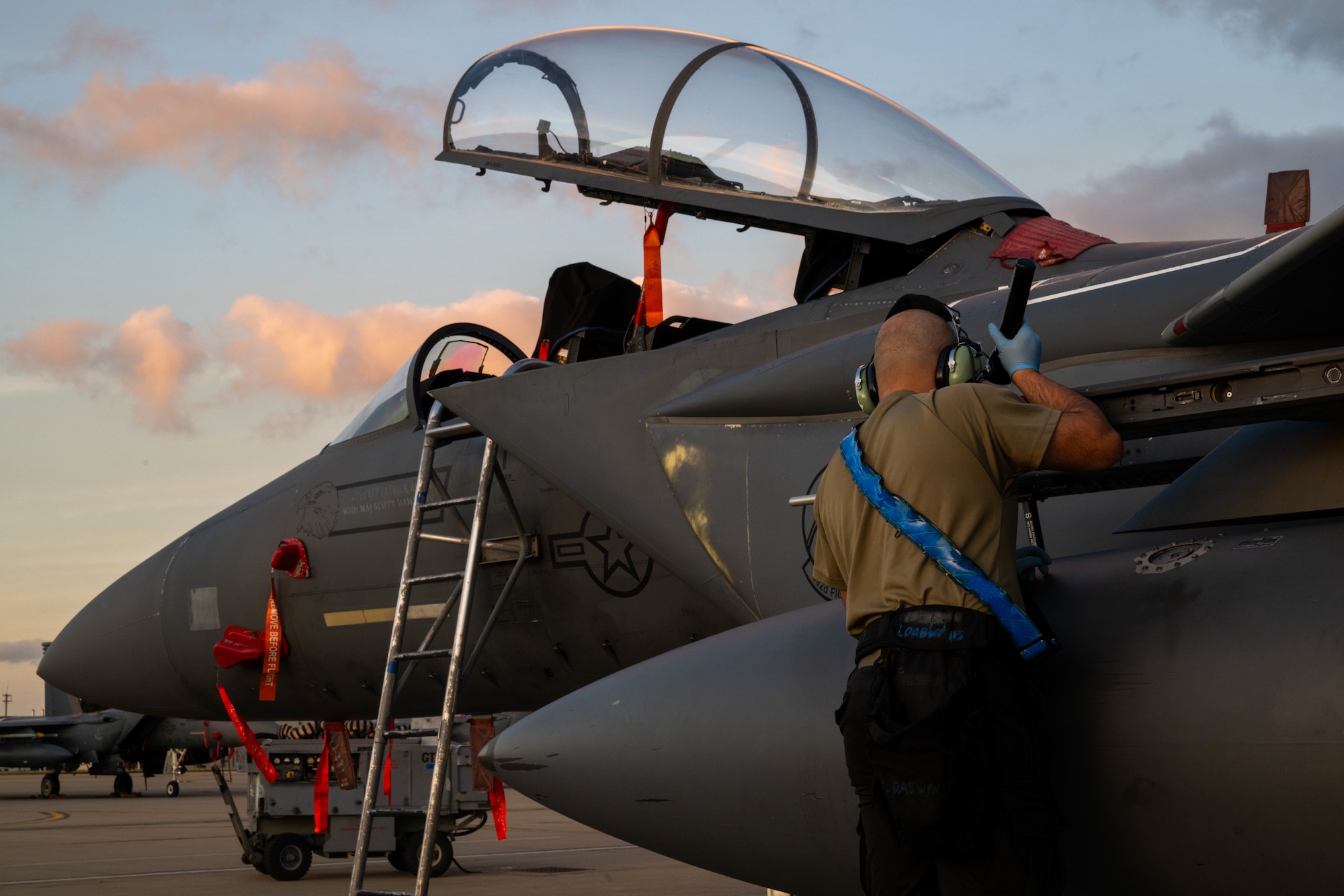 airman inspects jet