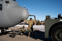 U.S. Air Force Airmen assigned to the 153rd Airlift Wing tow a C-130H Hercules aircraft out of a hangar in Cheyenne, Wyoming, Jan. 10, 2025, to support firefighting efforts in the Los Angeles area. U.S. Northern Command activated three Wyoming Air National Guard C-130s equipped with Modular Airborne Fire Fighting Systems and associated personnel to assist firefighting efforts in California.