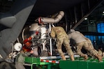 U.S. Air Force Airmen assigned to the 153rd Airlift Wing load and install the Modular Airborne Fire Fighting Systems onto a C-130H Hercules aircraft in Cheyenne, Wyoming, Jan. 10, 2025, in preparation to support firefighting efforts in the Los Angeles area.
