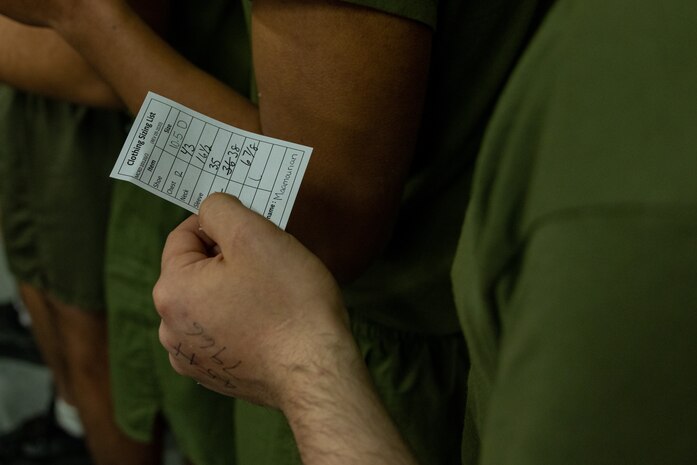 A U.S. Marine Corps Recruit with India Company, 3rd Recruit Training Battalion, holds his uniform size chart during their first uniform fitting at Marine Corps Recruit Depot San Diego, California, Jan. 7, 2025. Recruits are fitted several times throughout recruit training to ensure their uniforms are as ready as possible for wear as United States Marines. (U.S. Marine Corps photo by Lance Cpl. Jacob B. Hutchinson)