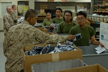 U.S. Marine Corps recruits with India Company, 3rd Recruit Training Battalion, receive uniform items during their first uniform fitting at Marine Corps Recruit Depot San Diego, California, Jan. 7, 2025. Recruits are fitted several times throughout recruit training to ensure their uniforms are as ready as possible for wear as United States Marines. (U.S. Marine Corps photo by Lance Cpl. Jacob B. Hutchinson)