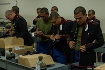 U.S. Marine Corps recruits with India Company, 3rd Recruit Training Battalion, try on Dress Blues coats during their first uniform fitting at Marine Corps Recruit Depot San Diego, California, Jan. 7, 2025. Recruits are fitted several times throughout recruit training to ensure their uniforms are as ready as possible for wear as United States Marines. (U.S. Marine Corps photo by Lance Cpl. Jacob B. Hutchinson)
