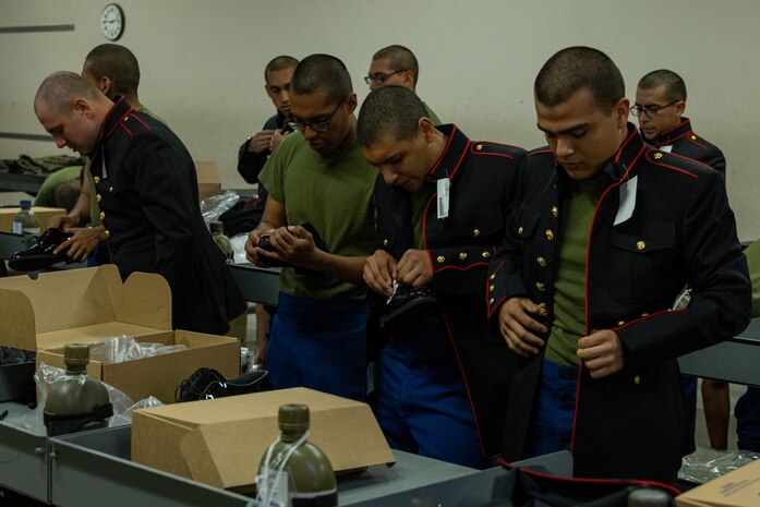 U.S. Marine Corps recruits with India Company, 3rd Recruit Training Battalion, try on Dress Blues coats during their first uniform fitting at Marine Corps Recruit Depot San Diego, California, Jan. 7, 2025. Recruits are fitted several times throughout recruit training to ensure their uniforms are as ready as possible for wear as United States Marines. (U.S. Marine Corps photo by Lance Cpl. Jacob B. Hutchinson)
