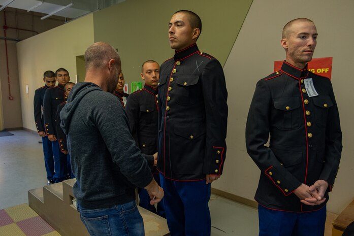 U.S. Marine Corps recruits with India Company, 3rd Recruit Training Battalion, are fitted for Dress Blues coats during their first uniform fitting at Marine Corps Recruit Depot San Diego, California, Jan. 7, 2025. Recruits are fitted several times throughout recruit training to ensure their uniforms are as ready as possible for wear as United States Marines. (U.S. Marine Corps photo by Lance Cpl. Jacob B. Hutchinson)