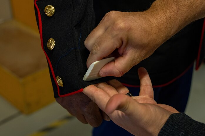 A U.S. Marine Corps recruit with India Company, 3rd Recruit Training Battalion, gets his Dress Blues coat fitted during their first uniform fitting at Marine Corps Recruit Depot San Diego, California, Jan. 7, 2025. Recruits are fitted several times throughout recruit training to ensure their uniforms are as ready as possible for wear as United States Marines. (U.S. Marine Corps photo by Lance Cpl. Jacob B. Hutchinson)