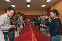 U.S. Marine Corps recruits with Delta Company, 1st Recruit Training Battalion, make a scripted phone call home during a receiving event at Marine Corps Recruit Depot San Diego, California, Jan. 6, 2025. During the receiving process, recruits are taken to the United Service Organizations for accountability, checked for contraband, given haircuts, make scripted phone calls home, and issued gear required for training. Our Marines continue to serve their nation and their Corps through their lived examples of our values and by helping to identify and select potential recruits who may have what it takes to earn the title. (U.S. Marine Corps photo by Lance Cpl. Janell B. Alvarez)