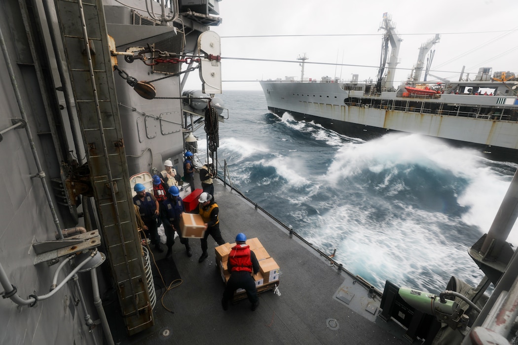 Sailors unload supplies aboard USS Princeton (CG 59) during a replenishment with USNS Tippecanoe (T-AO 199) in the South China Sea.