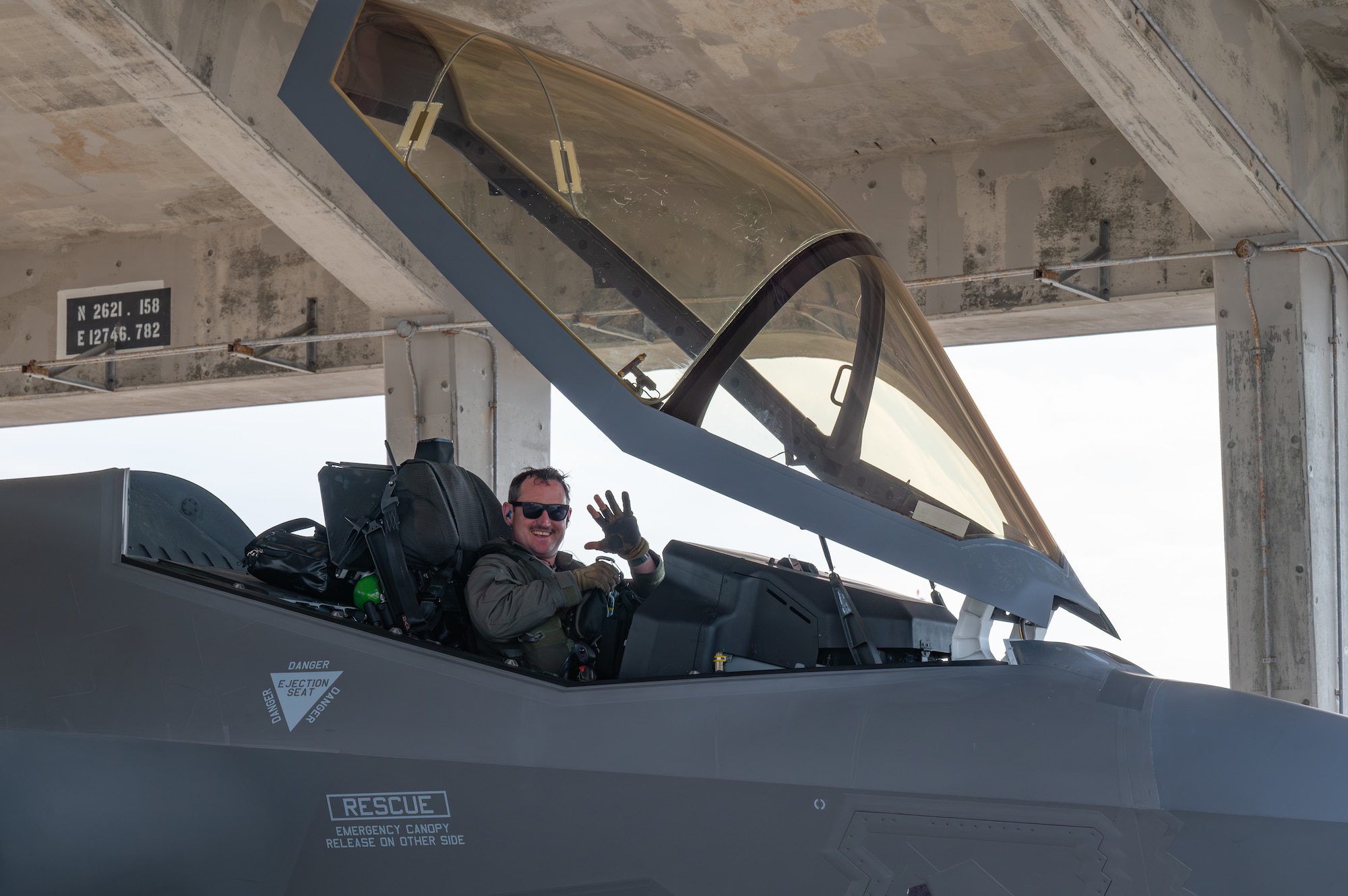 A U.S. Air Force F-35A Lightning II pilot assigned to the 134th Expeditionary Fighter Squadron waves after arriving at Kadena Air Base, Japan, Jan. 13, 2025.