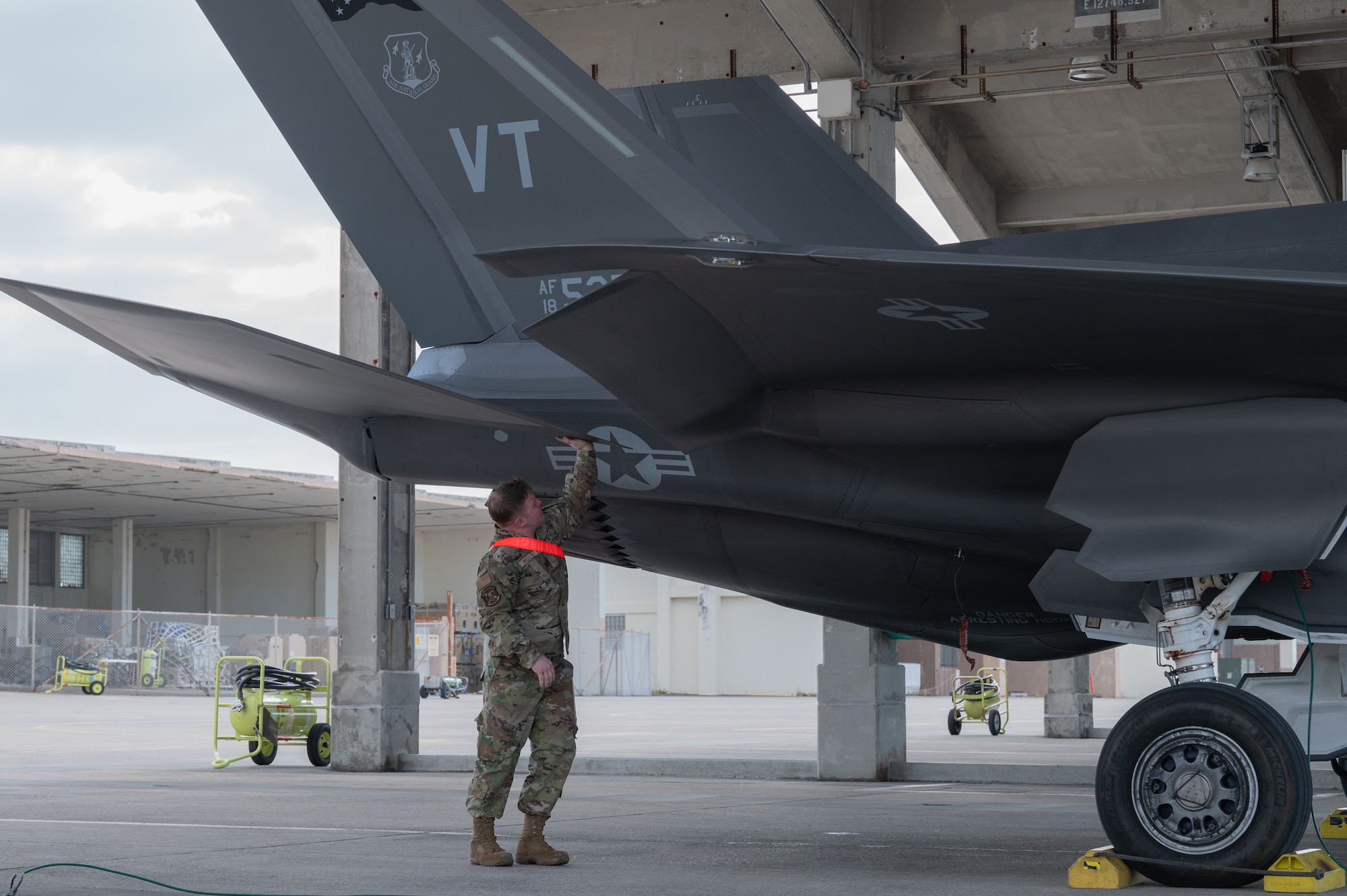 U.S. Air Force Senior Airman Jacob Millette, 134th Fighter Generation Squadron, crew chief, conducts post-flight procedures on an F-35A Lightning II after arriving at Kadena Air Base, Japan, Jan. 13, 2025
