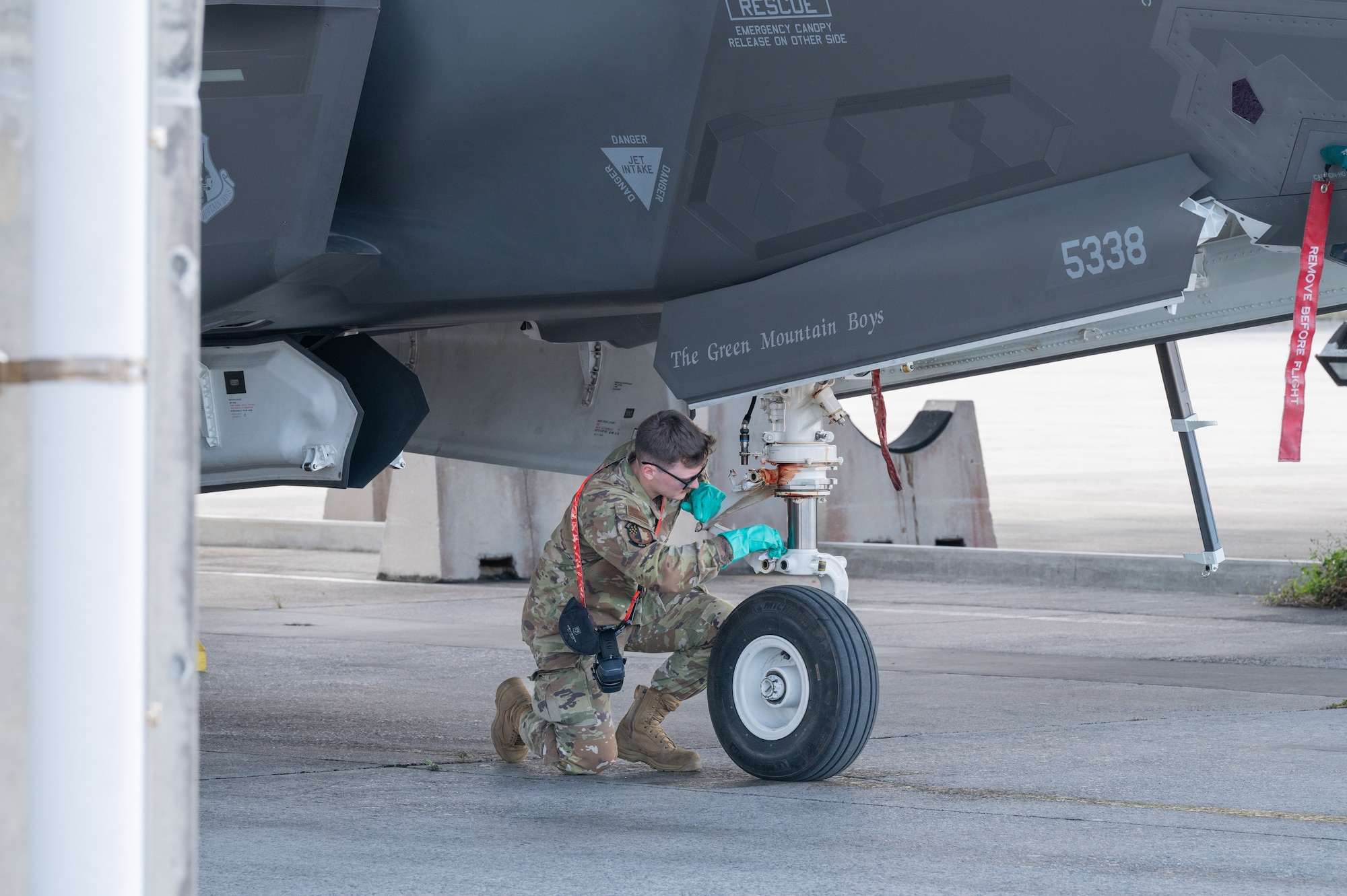 U.S. Air Force Senior Airman Kipp Kelsey, 134th Fighter Generation Squadron, crew chief, wipes an F-35A Lightning II’s landing gear after arriving at Kadena Air Base, Japan, Jan. 13, 2025.