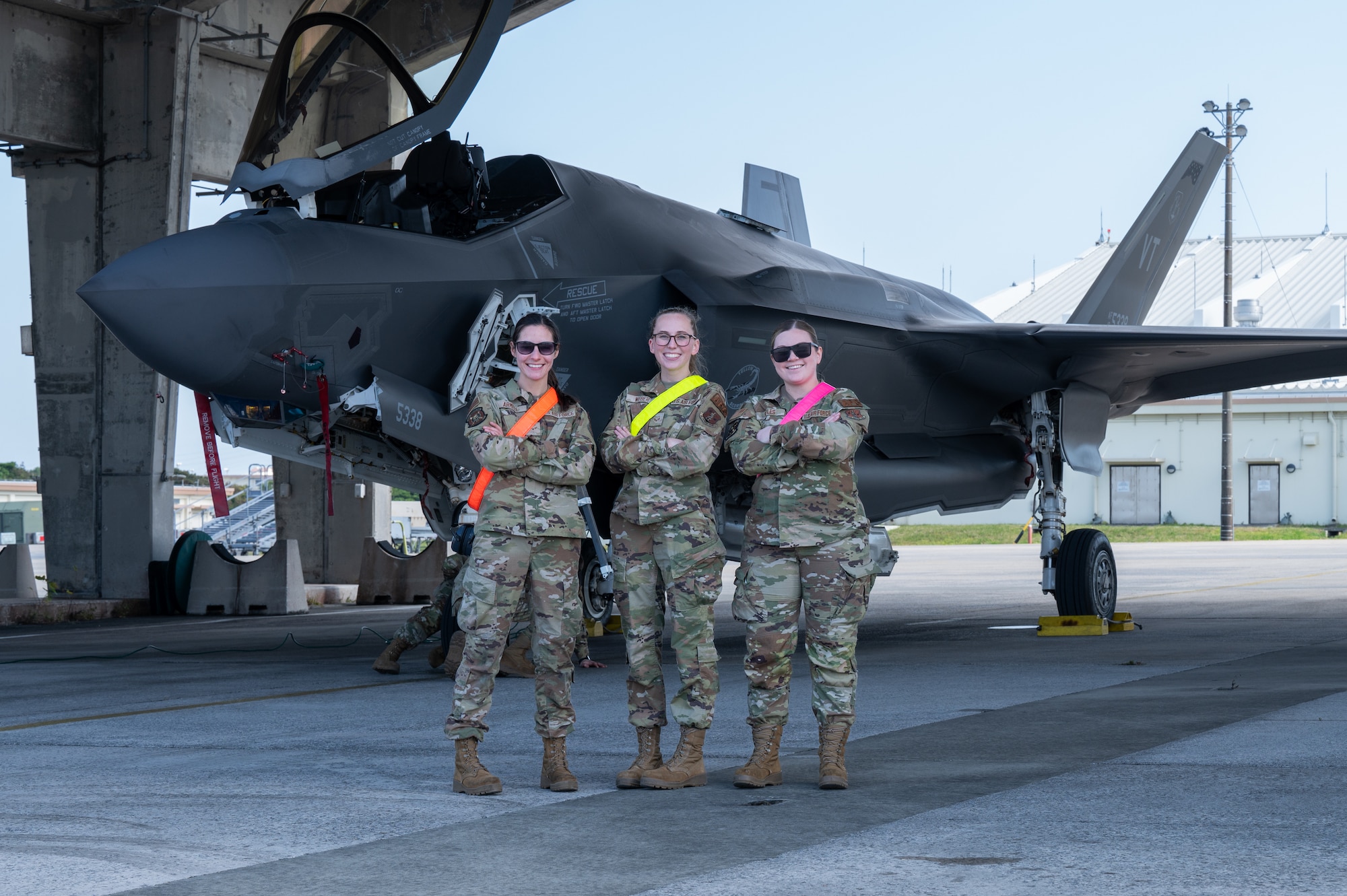 .S. Air Force Airman 1st Class Felicia Armell, left, Senior Airman Sydney Weber, middle, and Tech. Sgt. Hailey Sayles, 134th Fighter Generation Squadron, crew chiefs, pose for a photo in front of an F-35A Lightning II after arriving at Kadena Air Base, Japan, Jan. 13, 2025.