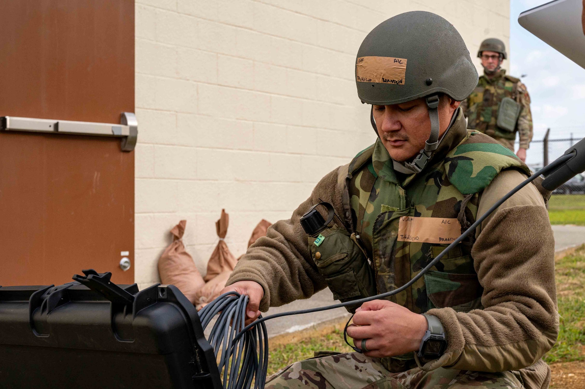 Service member sets up equipment.