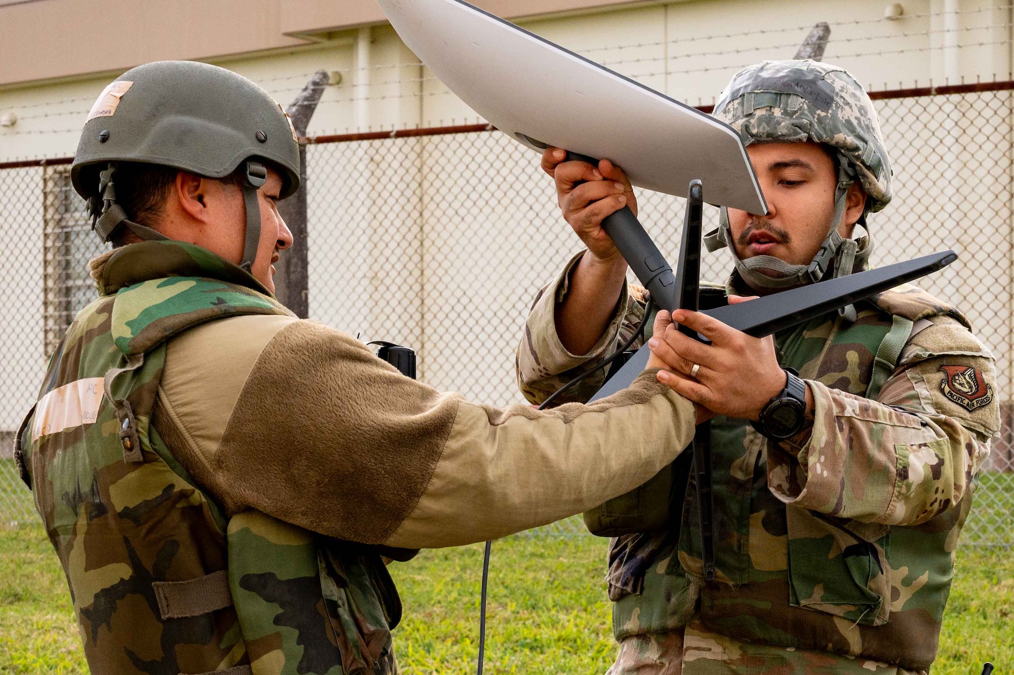 Service members set up equipment.