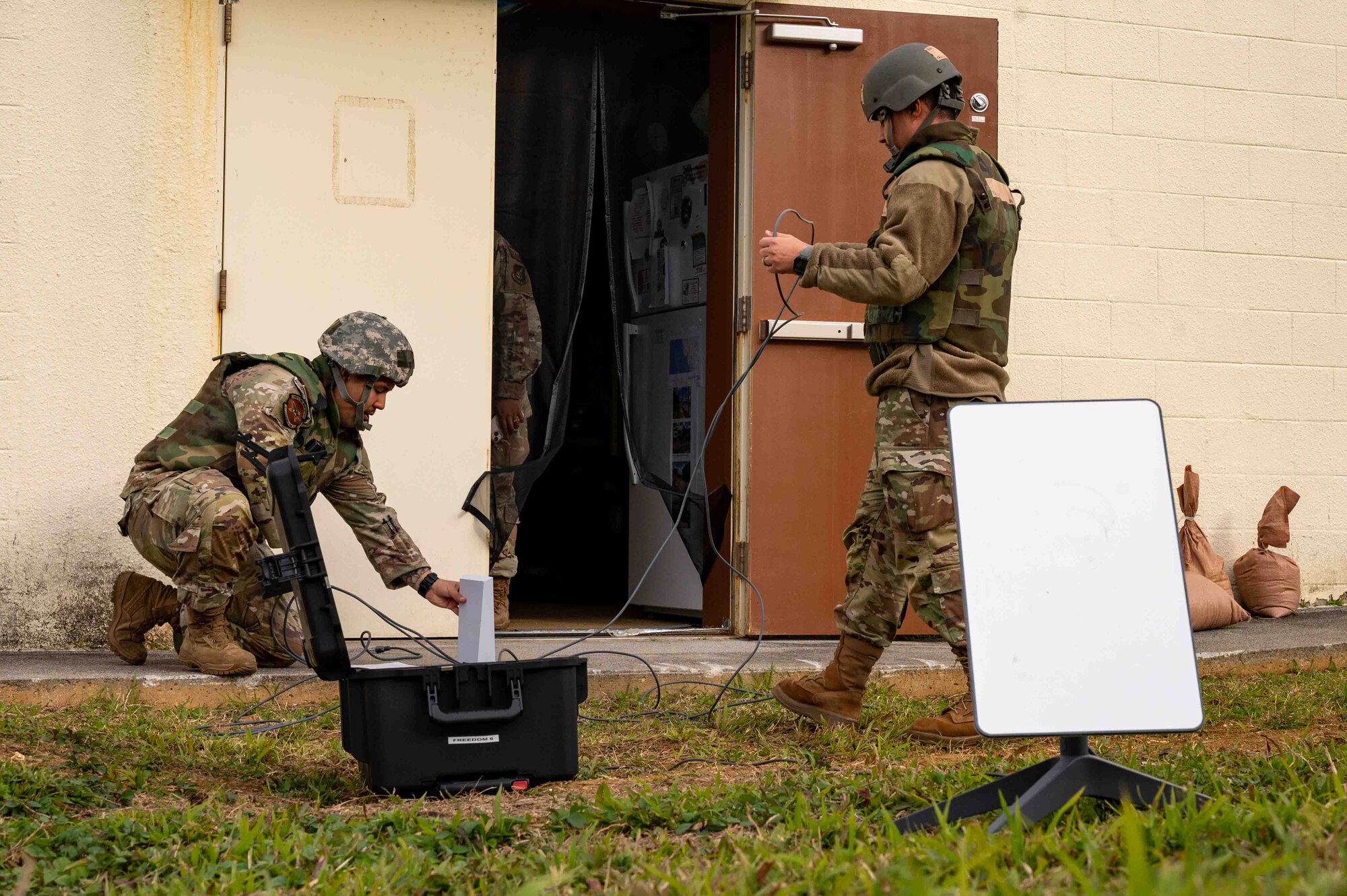 Service members set up equipment.