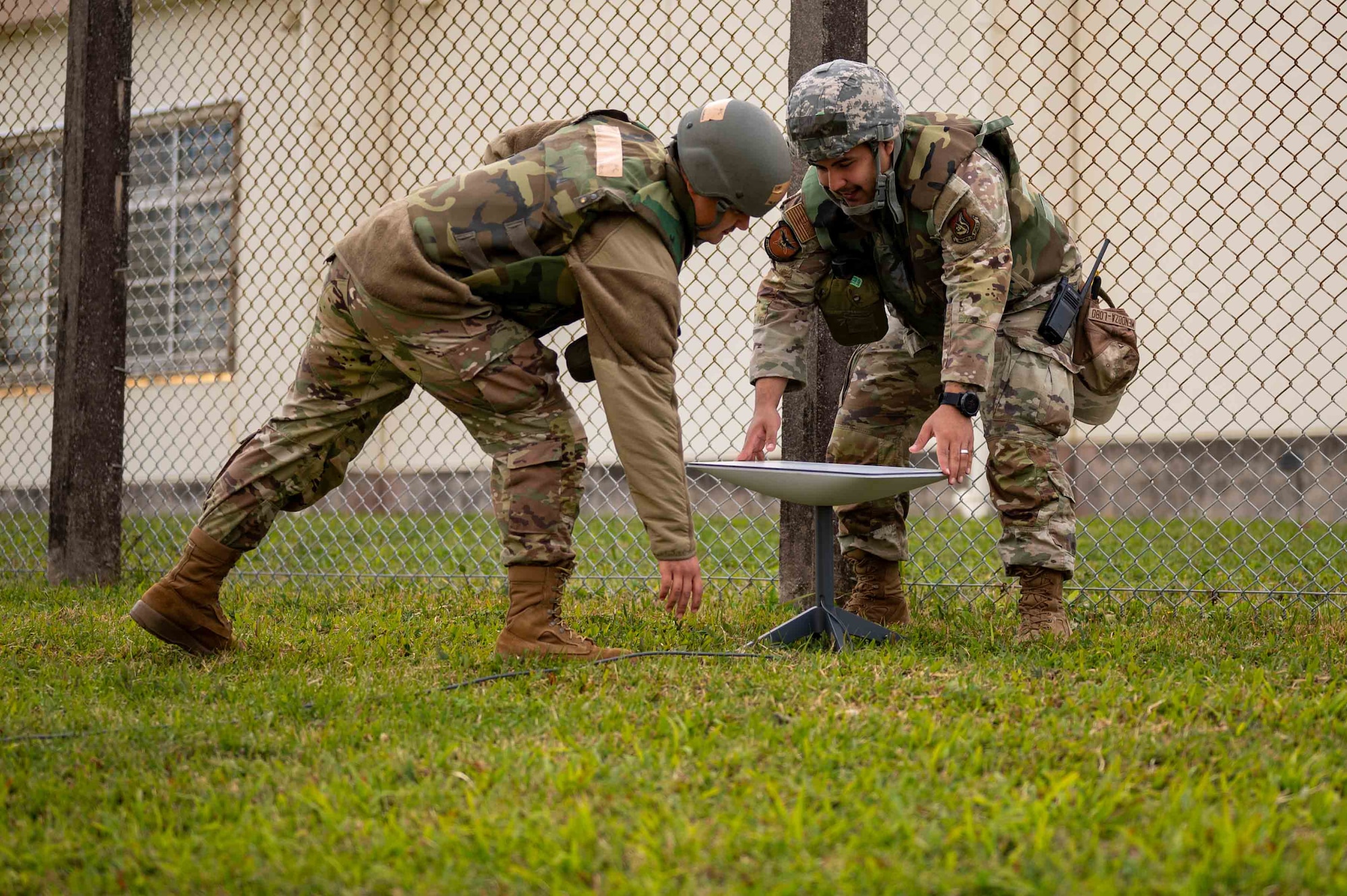 Service members set up equipment.
