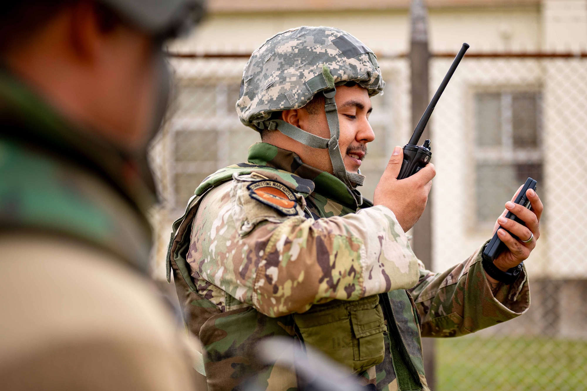 Service member speaks into radio.