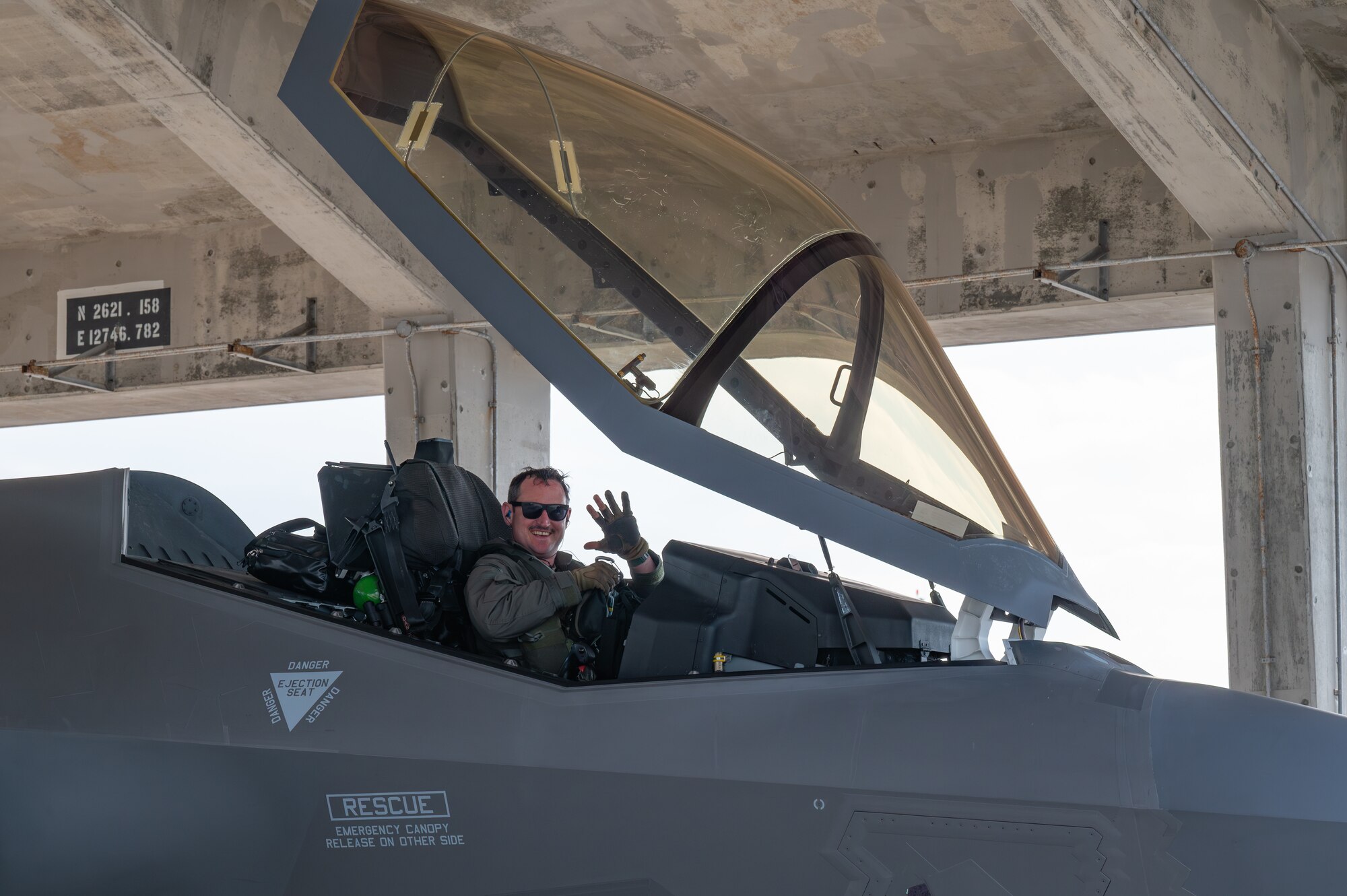 A U.S. Air Force F-35A Lightning II pilot assigned to the 134th Expeditionary Fighter Squadron waves after arriving at Kadena Air Base, Japan, Jan. 13, 2025.