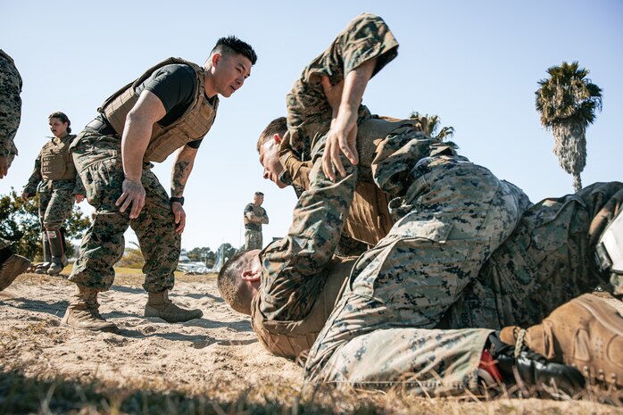 U.S. Marines from Marine Corps Recruit Depot San Diego and Marine Corps Base Camp Pendleton participate in a culminating event during a Marine Corps Martial Arts Instructor Course at MCRD San Diego, California, Dec. 18, 2024. After three weeks of training, MAI Course Class 19-24 conducted a five-hour culminating event that challenged students to show expertise in ground fighting, weapons-free sparring, and bayonet and knife techniques. (U.S. Marine Corps photo by Cpl. Sarah M. Grawcock)