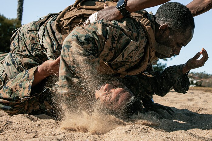 U.S. Marines from Marine Corps Recruit Depot San Diego and Marine Corps Base Camp Pendleton participate in a culminating event during a Marine Corps Martial Arts Instructor Course at MCRD San Diego, California, Dec. 18, 2024. After three weeks of training, the five-hour culminating event challenged students to show expertise in ground fighting, weapons-free sparring, and bayonet and knife techniques. (U.S. Marine Corps photo by Cpl. Sarah M. Grawcock)