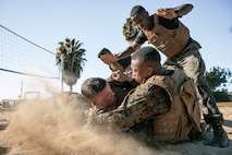 U.S. Marine Corps Martial Arts Instructor Trainer, Sgt. David Hamptonfur with Support Battalion, Recruit Training Regiment, Marine Corps Recruit Depot San Diego, observes Marines participate in a culminating event during a Marine Corps Martial Arts Instructor Course at MCRD San Diego, California, Dec. 18, 2024. After three weeks of training, MAI Course Class 19-24 conducted a five-hour culminating event that challenged students to show expertise in ground fighting, weapons-free sparring, and bayonet and knife techniques. (U.S. Marine Corps photo by Cpl. Sarah M. Grawcock)