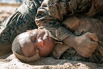 U.S. Marines from Marine Corps Recruit Depot San Diego and Marine Corps Base Camp Pendleton participate in a culminating event during a Marine Corps Martial Arts Instructor Course at MCRD San Diego, California, Dec. 18, 2024. After three weeks of training, MAI Course Class 19-24 conducted a five-hour culminating event that challenged students to show expertise in ground fighting, weapons-free sparring, and bayonet and knife techniques. (U.S. Marine Corps photo by Cpl. Sarah M. Grawcock)