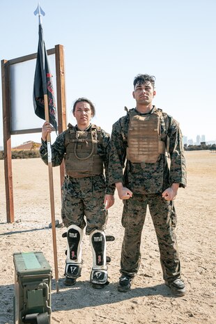 U.S. Marine Corps Series Chief Drill Instructor, Staff Sgt. William Mckoy, right, with Mike Company, 3rd Recruit Training Battalion, Recruit Training Regiment, and a Food Service Specialist, Sgt. Veronica Reed with Headquarters and Service Battalion, both with Marine Corps Recruit Depot San Diego, pose for a photo during a culminating event as part of a Marine Corps Martial Arts Instructor Course at MCRD San Diego, California, Dec. 18, 2024. After three weeks of training, MAI Course Class 19-24 conducted a five-hour culminating event that challenged students to show expertise in ground fighting, weapons-free sparring, and bayonet and knife techniques. (U.S. Marine Corps photo by Cpl. Sarah M. Grawcock)