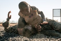 U.S. Marine Corps Martial Arts Instructor Trainer, Sgt. David Hamptonfur with Support Battalion, Recruit Training Regiment, Marine Corps Recruit Depot San Diego, challenges a Marine during the culminating event of a Marine Corps Martial Arts Instructor Course at MCRD San Diego, California, Dec. 18, 2024. After three weeks of training, MAI Course Class 19-24 conducted a five-hour culminating event that challenged students to show expertise in ground fighting, weapons-free sparring, and bayonet and knife techniques. (U.S. Marine Corps photo by Cpl. Sarah M. Grawcock)