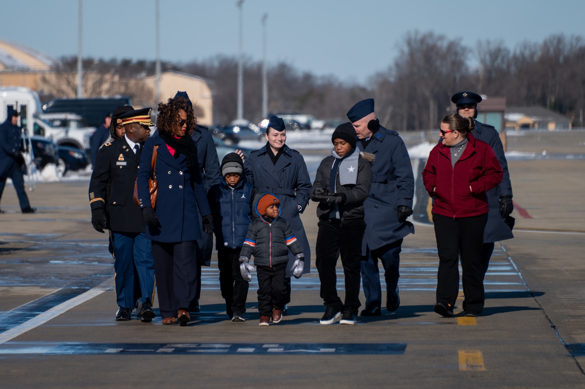 U.S. service members assigned within the National Capital Region, and family members, arrive on the flight line prior to the departure ceremony for the State Funeral of former President Jimmy Carter at Joint Base Andrews, Md., Jan. 9, 2025. Among Department of Defense leadership, approximately 200 military families across the NCR attended the departure ceremony to bid farewell to the former president. (U.S. Air Force photo by Staff Sgt. Alex Broome)