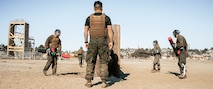 U.S. Marine Corps Martial Arts Instructor Trainer, Staff Sgt. Patrick Chok with Support Battalion, Marine Corps Recruit Depot San Diego, observes Marines participating in a culminating event during a Marine Corps Martial Arts Instructor Course at MCRD San Diego, California, Dec. 18, 2024. After three weeks of training, MAI Course Class 19-24 conducted a five-hour culminating event that challenged students to show expertise in ground fighting, weapons-free sparring, and bayonet and knife techniques. (U.S. Marine Corps photo by Cpl. Sarah M. Grawcock)