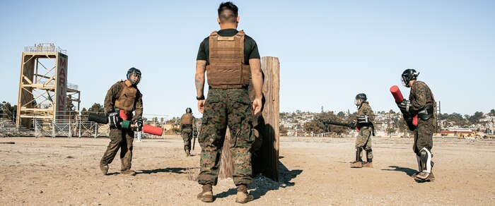 U.S. Marine Corps Martial Arts Instructor Trainer, Staff Sgt. Patrick Chok with Support Battalion, Marine Corps Recruit Depot San Diego, observes Marines participating in a culminating event during a Marine Corps Martial Arts Instructor Course at MCRD San Diego, California, Dec. 18, 2024. After three weeks of training, MAI Course Class 19-24 conducted a five-hour culminating event that challenged students to show expertise in ground fighting, weapons-free sparring, and bayonet and knife techniques. (U.S. Marine Corps photo by Cpl. Sarah M. Grawcock)