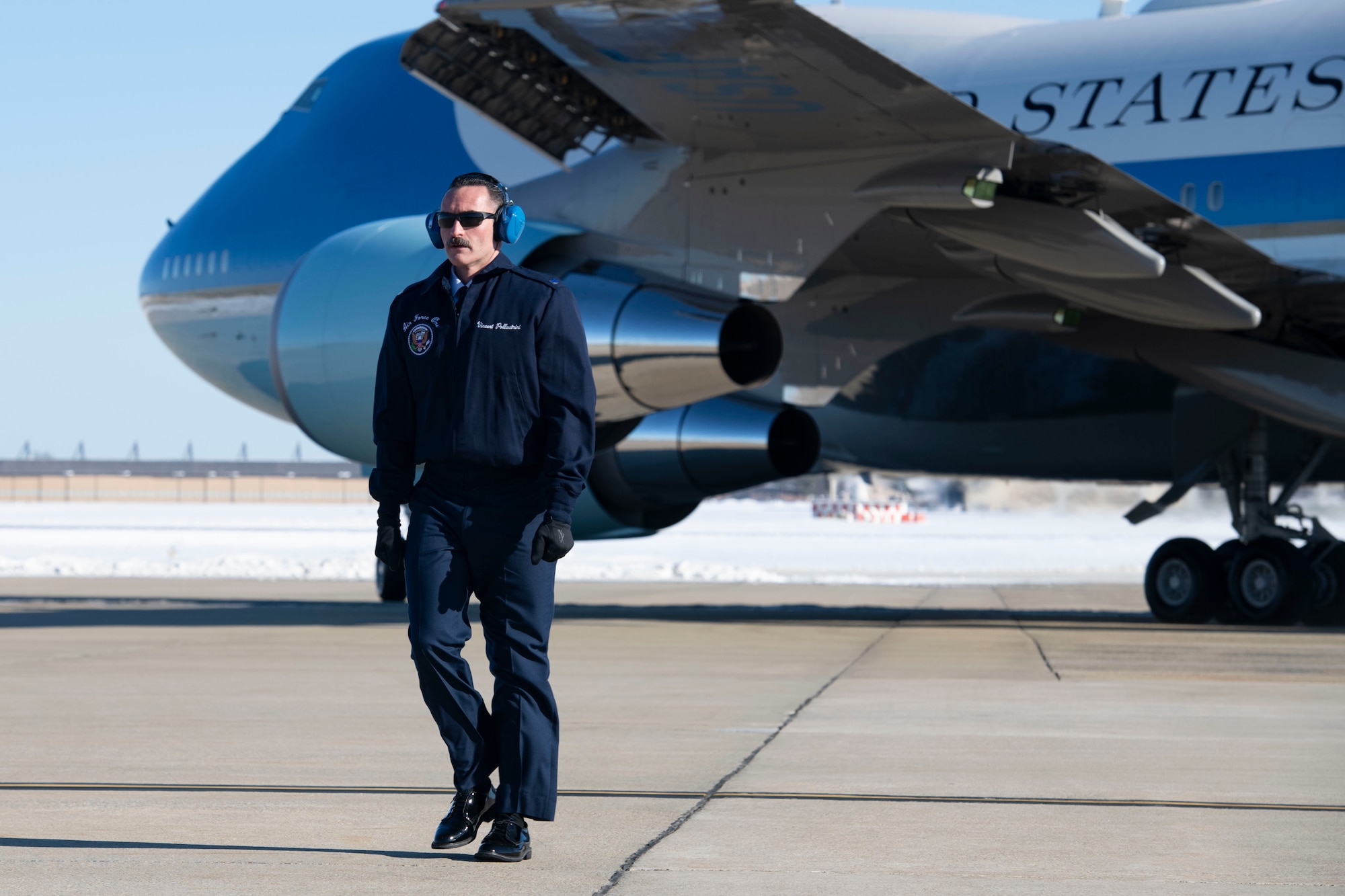 U.S. Air Force Staff Sgt. Vincent Pollastrini, assigned to the Presidential Airlift Group, crosses the flight line after marshalling Special Air Mission 39 during the departure ceremony for the State Funeral of former President Jimmy Carter at Joint Base Andrews, Md., Jan. 9, 2025. SAM 39, the designated call sign for the VC-25 aircraft during Carter’s state funeral ceremonies, is otherwise known as Air Force One when the president is aboard. (U.S. Air Force photo by Senior Airman Julia Lebens)