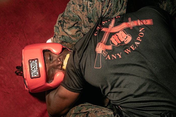 U.S. Marine Corps Martial Arts Instructor Trainer, Sgt. David Hamptonfur with Support Battalion, Recruit Training Regiment, Marine Corps Recruit Depot San Diego, challenges a Marine during the culminating event of a Marine Corps Martial Arts Instructor Course at MCRD San Diego, California, Dec. 18, 2024. After three weeks of training, MAI Course Class 19-24 conducted a five-hour culminating event that challenged students to show expertise in ground fighting, weapons-free sparring, and bayonet and knife techniques. (U.S. Marine Corps photo by Cpl. Sarah M. Grawcock)