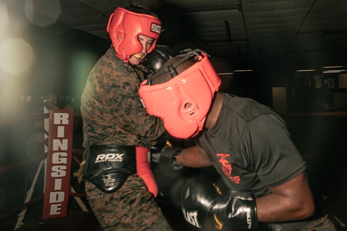 U.S. Marine Corps Martial Arts Instructor Trainer, Sgt. Ricardo Fleuridor with Support Battalion, Recruit Training Regiment, Marine Corps Recruit Depot San Diego, challenges a Marine during the culminating event of a Marine Corps Martial Arts Instructor Course at MCRD San Diego, California, Dec. 18, 2024. After three weeks of training, MAI Course Class 19-24 conducted a five-hour culminating event that challenged students to show expertise in ground fighting, weapons-free sparring, and bayonet and knife techniques. (U.S. Marine Corps photo by Cpl. Sarah M. Grawcock)