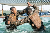 U.S. Marines from Marine Corps Recruit Depot San Diego and Marine Corps Base Camp Pendleton participate in a culminating event during a Marine Corps Martial Arts Instructor Course at MCRD San Diego, California, Dec. 18, 2024. After three weeks of training, MAI Course Class 19-24 conducted a five-hour culminating event that challenged students to show expertise in ground fighting, weapons-free sparring, and bayonet and knife techniques. (U.S. Marine Corps photo by Cpl. Sarah M. Grawcock)