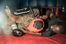 U.S. Marine Corps Martial Arts Instructor Trainer, Sgt. Ricardo Fleuridor with Support Battalion, Recruit Training Regiment, Marine Corps Recruit Depot San Diego, challenges a Marine during the culminating event of a Marine Corps Martial Arts Instructor Course at MCRD San Diego, California, Dec. 18, 2024. After three weeks of training, MAI Course Class 19-24 conducted a five-hour culminating event that challenged students to show expertise in ground fighting, weapons-free sparring, and bayonet and knife techniques. (U.S. Marine Corps photo by Cpl. Sarah M. Grawcock)
