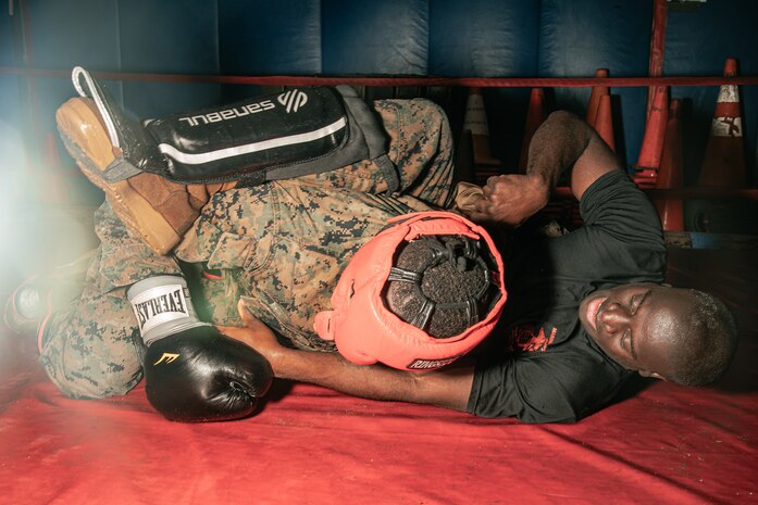U.S. Marine Corps Martial Arts Instructor Trainer, Sgt. Ricardo Fleuridor with Support Battalion, Recruit Training Regiment, Marine Corps Recruit Depot San Diego, challenges a Marine during the culminating event of a Marine Corps Martial Arts Instructor Course at MCRD San Diego, California, Dec. 18, 2024. After three weeks of training, MAI Course Class 19-24 conducted a five-hour culminating event that challenged students to show expertise in ground fighting, weapons-free sparring, and bayonet and knife techniques. (U.S. Marine Corps photo by Cpl. Sarah M. Grawcock)