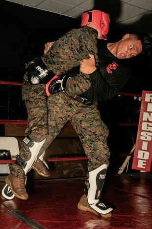 U.S. Marine Corps Martial Arts Instructor Trainer, Sgt. Sean Okeefe with Support Battalion, Recruit Training Regiment, Marine Corps Recruit Depot San Diego, challenges a Marine during the culminating event of a Marine Corps Martial Arts Instructor Course at MCRD San Diego, California, Dec. 18, 2024. After three weeks of training, MAI Course Class 19-24 conducted a five-hour culminating event that challenged students to show expertise in ground fighting, weapons-free sparring, and bayonet and knife techniques. (U.S. Marine Corps photo by Cpl. Sarah M. Grawcock)