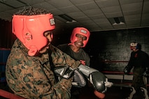 U.S. Marine Corps Martial Arts Instructor Trainer, Sgt. David Hamptonfur with Support Battalion, Recruit Training Regiment, Marine Corps Recruit Depot San Diego, challenges a Marine during the culminating event of a Marine Corps Martial Arts Instructor Course at MCRD San Diego, California, Dec. 18, 2024. After three weeks of training, MAI Course Class 19-24 conducted a five-hour culminating event that challenged students to show expertise in ground fighting, weapons-free sparring, and bayonet and knife techniques. (U.S. Marine Corps photo by Cpl. Sarah M. Grawcock)