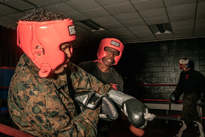 U.S. Marine Corps Martial Arts Instructor Trainer, Sgt. David Hamptonfur with Support Battalion, Recruit Training Regiment, Marine Corps Recruit Depot San Diego, challenges a Marine during the culminating event of a Marine Corps Martial Arts Instructor Course at MCRD San Diego, California, Dec. 18, 2024. After three weeks of training, MAI Course Class 19-24 conducted a five-hour culminating event that challenged students to show expertise in ground fighting, weapons-free sparring, and bayonet and knife techniques. (U.S. Marine Corps photo by Cpl. Sarah M. Grawcock)
