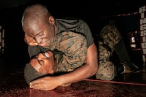 U.S. Marine Corps Martial Arts Instructor Trainer, Sgt. Ricardo Fleuridor with Support Battalion, Recruit Training Regiment, Marine Corps Recruit Depot San Diego, challenges a Marine during the culminating event of a Marine Corps Martial Arts Instructor Course at MCRD San Diego, California, Dec. 18, 2024. After three weeks of training, MAI Course Class 19-24 conducted a five-hour culminating event that challenged students to show expertise in ground fighting, weapons-free sparring, and bayonet and knife techniques. (U.S. Marine Corps photo by Cpl. Sarah M. Grawcock)