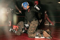 U.S. Marine Corps Martial Arts Instructor Trainer, Sgt. Sean Okeefe with Support Battalion, Recruit Training Regiment, Marine Corps Recruit Depot San Diego, challenges a Marine during the culminating event of a Marine Corps Martial Arts Instructor Course at MCRD San Diego, California, Dec. 18, 2024. After three weeks of training, MAI Course Class 19-24 conducted a five-hour culminating event that challenged students to show expertise in ground fighting, weapons-free sparring, and bayonet and knife techniques. (U.S. Marine Corps photo by Cpl. Sarah M. Grawcock)