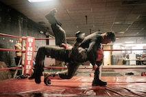 U.S. Marine Corps Martial Arts Instructor Trainer, Sgt. Sean Okeefe with Support Battalion, Recruit Training Regiment, Marine Corps Recruit Depot San Diego, challenges a Marine during the culminating event of a Marine Corps Martial Arts Instructor Course at MCRD San Diego, California, Dec. 18, 2024. After three weeks of training, MAI Course Class 19-24 conducted a five-hour culminating event that challenged students to show expertise in ground fighting, weapons-free sparring, and bayonet and knife techniques. (U.S. Marine Corps photo by Cpl. Sarah M. Grawcock)