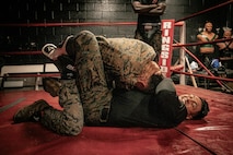 U.S. Marine Corps Martial Arts Instructor Trainer, Sgt. Sean Okeefe with Support Battalion, Recruit Training Regiment, Marine Corps Recruit Depot San Diego, challenges a Marine during the culminating event of a Marine Corps Martial Arts Instructor Course at MCRD San Diego, California, Dec. 18, 2024. After three weeks of training, MAI Course Class 19-24 conducted a five-hour culminating event that challenged students to show expertise in ground fighting, weapons-free sparring, and bayonet and knife techniques. (U.S. Marine Corps photo by Cpl. Sarah M. Grawcock)